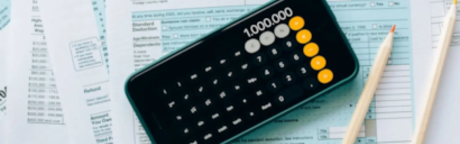 A calculator sitting on spreadsheets